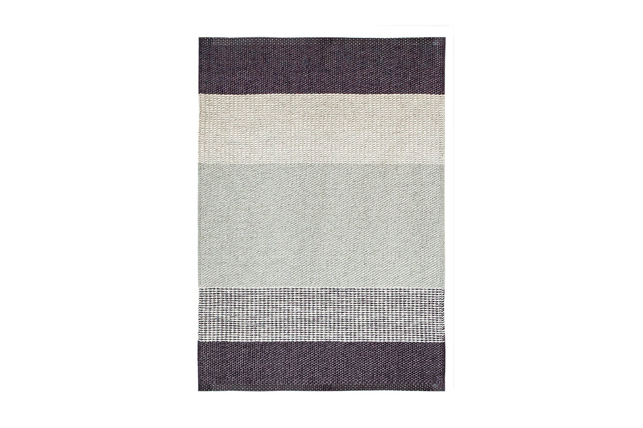 Seasons Woven Plastic Rug by Brita, showing back view of seasons woven plastic rug in berry seasons woven rug.