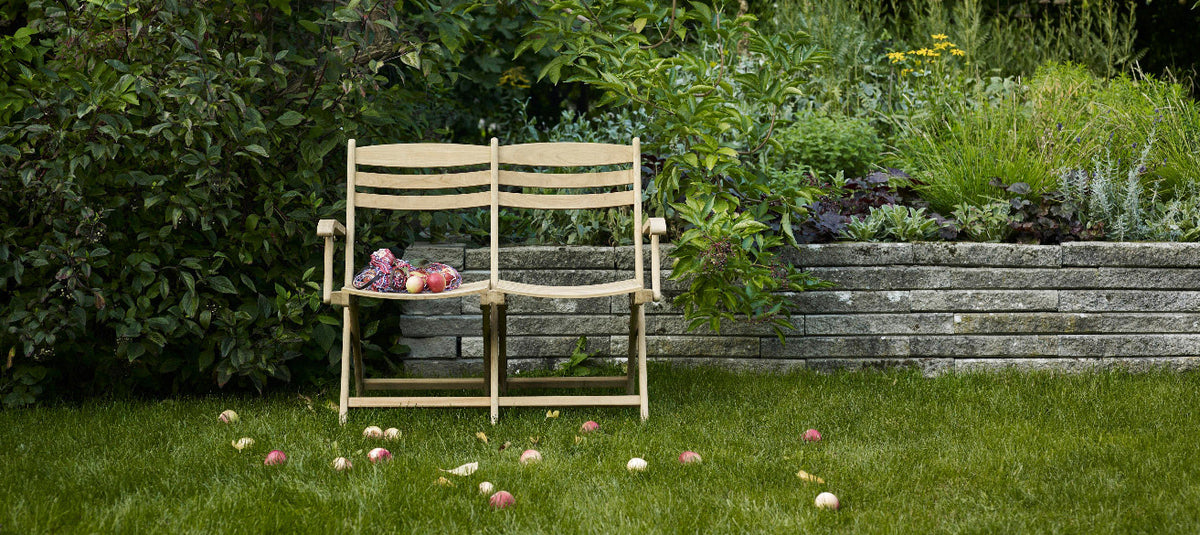 Selandia Outdoor 2-Seater Chair by Skagerak, showing selandia outdoor 2-seater chair in live shot.