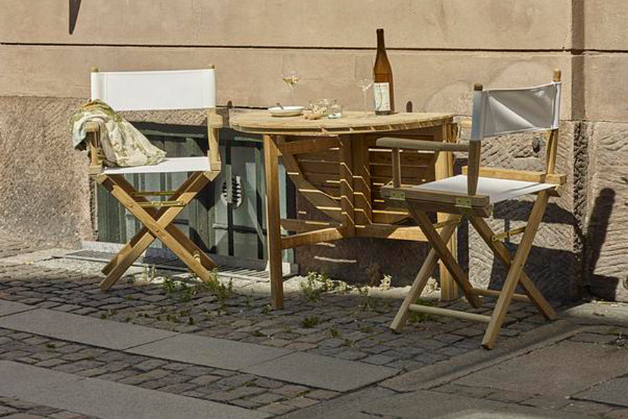 Selandia Outdoor Dining Table by Skagerak, showing selandia outdoor dining table with chairs in live shot.