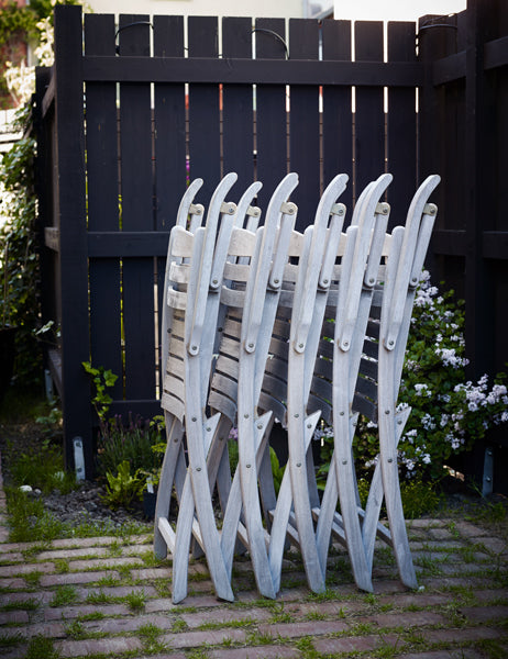 Selandia Teak Armchair by Skagerak, showing selandia teak armchairs in live shot.