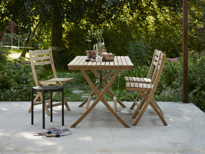 Selandia Teak Chair by Skagerak, showing selandia teak chairs with table in live shot.