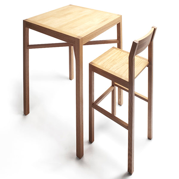 Seminar KVBT1 Bar Chair by Nikari, showing back view of seminar kvbt1 bar chair in oak with bar table.