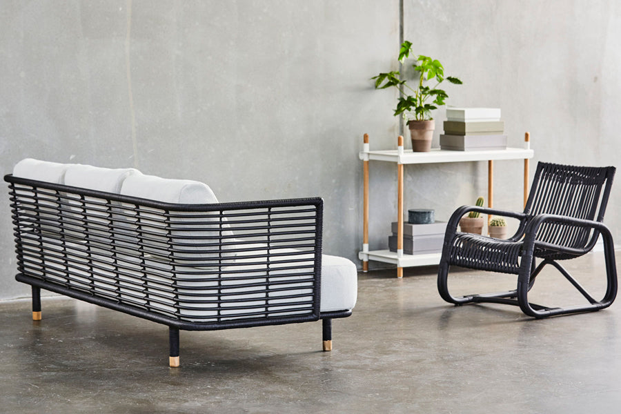 Sense Indoor 3-seater Sofa by Cane-Line, showing sense indoor 3-seater sofa with chair in live shot.