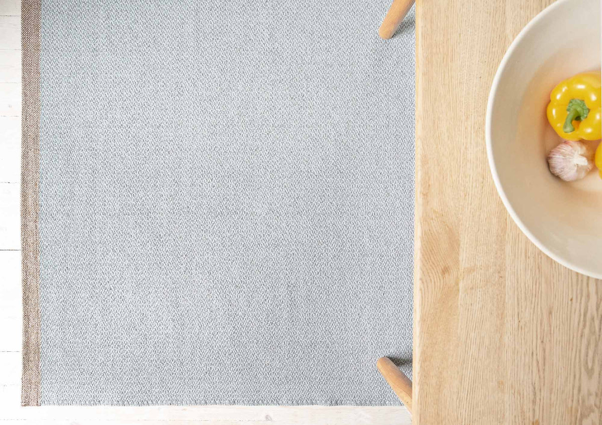 Shade Woven Plastic Rug by Brita, showing closeup view of shade woven plastic rug in live shot.