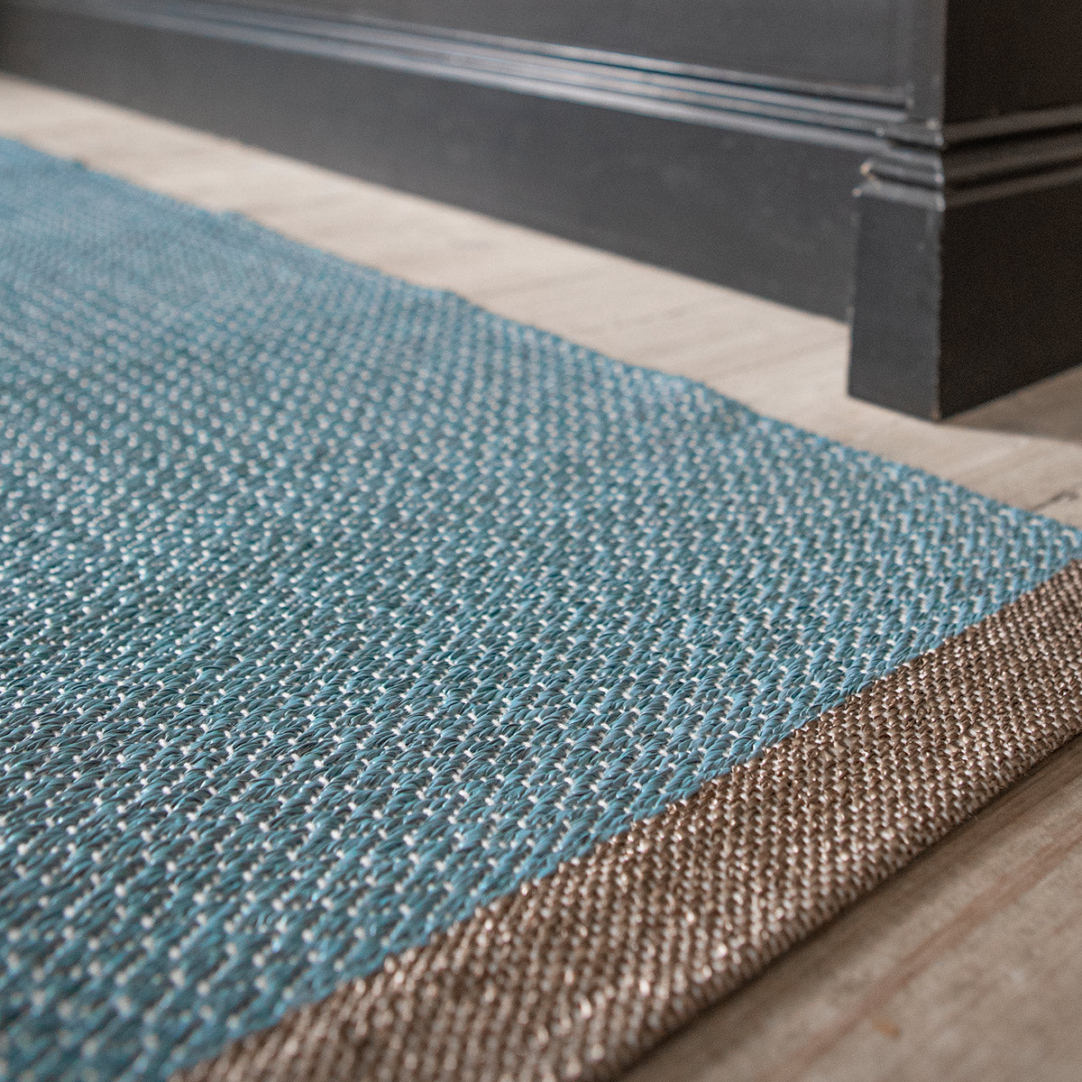 Shade Woven Plastic Rug by Brita, showing closeup view of shade woven plastic rug in live shot.