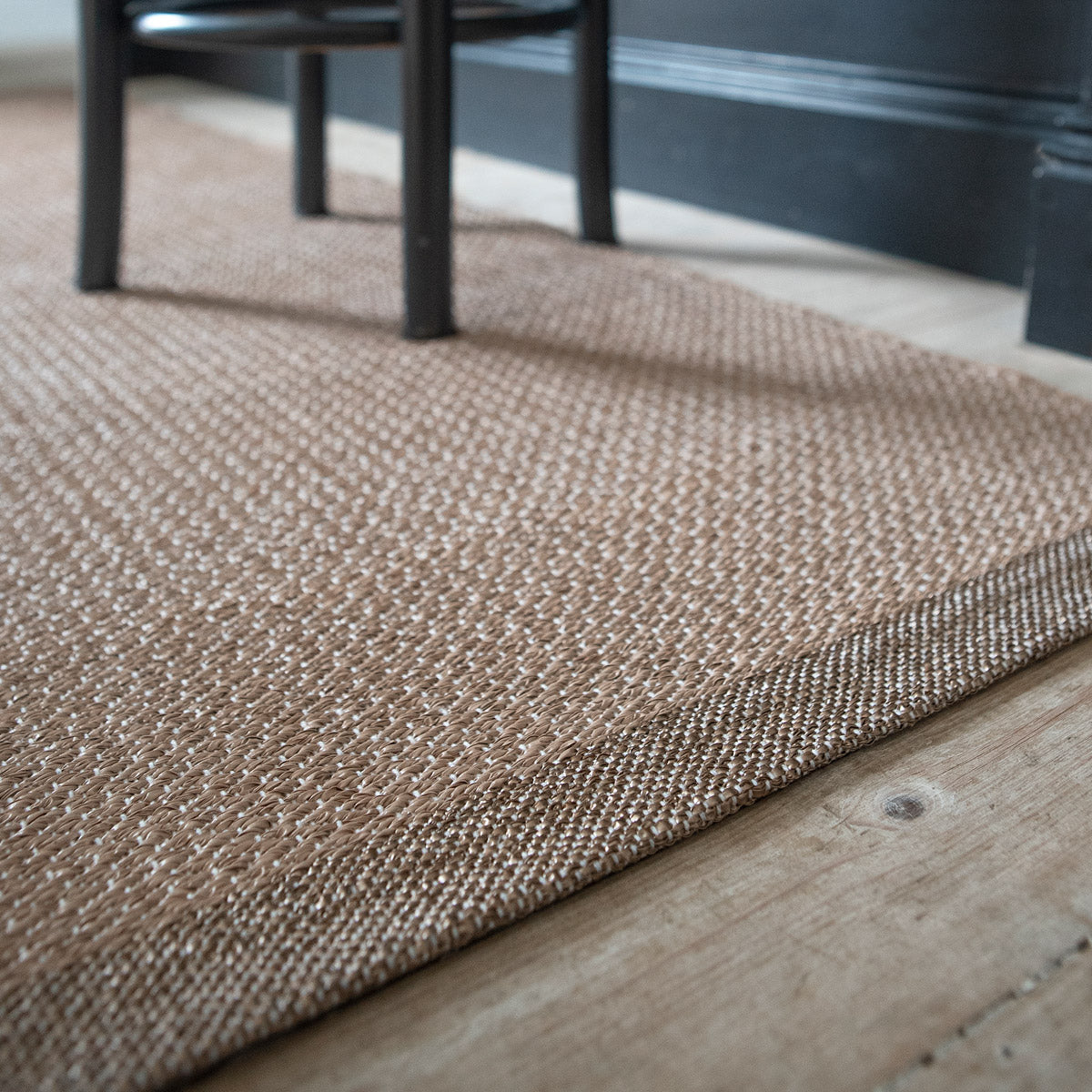 Shade Woven Plastic Rug by Brita, showing closeup view of shade woven plastic rug in live shot.