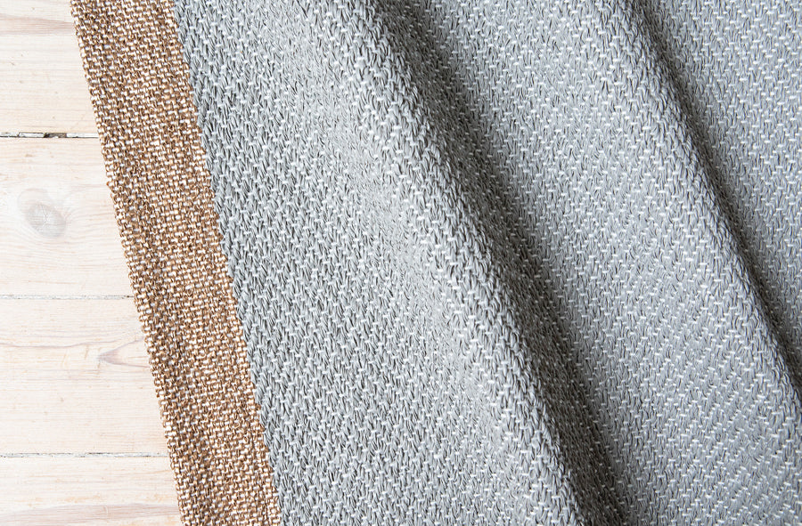 Shade Woven Plastic Rug by Brita, showing closeup view of shade woven plastic rug in live shot.