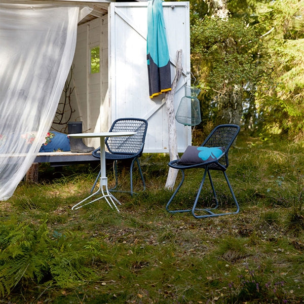 Sixties Side Chair by Fermob, showing side chair with table & pillow in live shot.