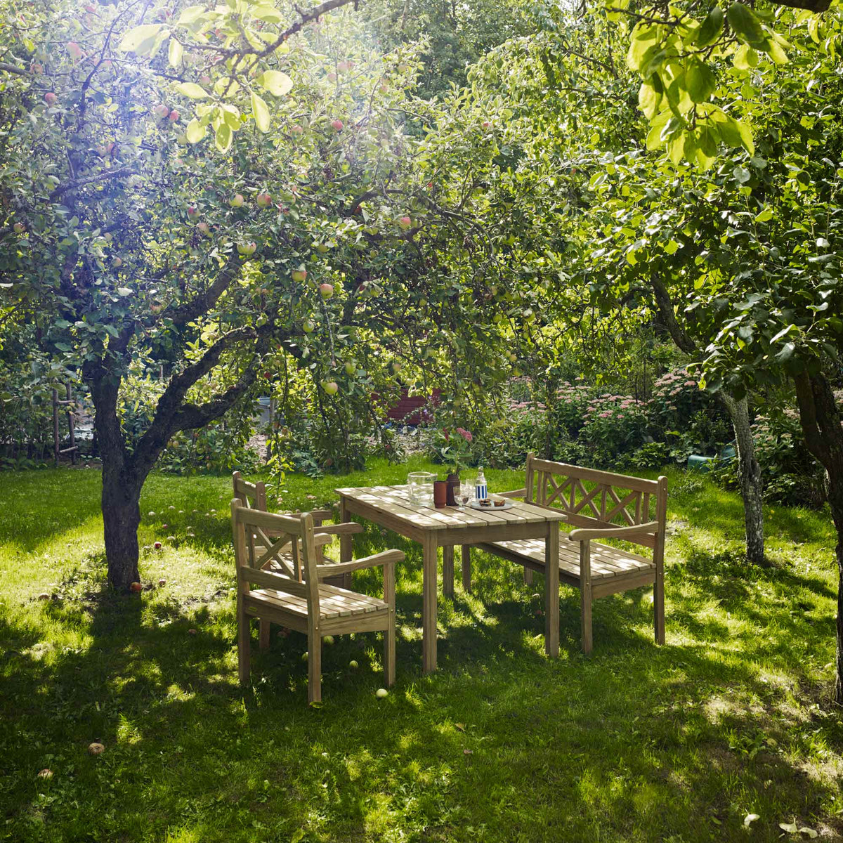 Skagen Chair by Skagerak, showing skagen chairs with bench & table in live shot.