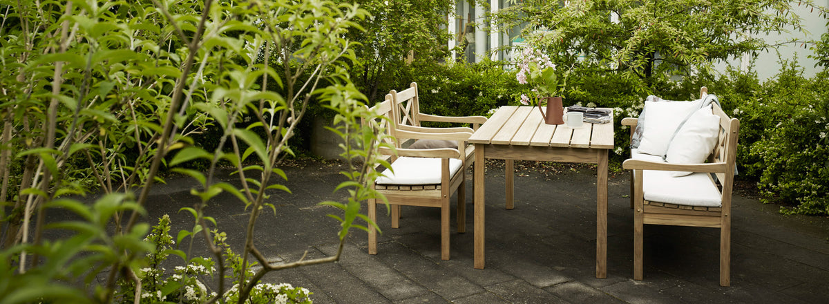 Skagen Chair by Skagerak, showing skagen chairs with bench & table in live shot.
