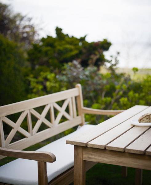 Skagen Table by Skagerak, showing closeup view of skagen table with bench in live shot.