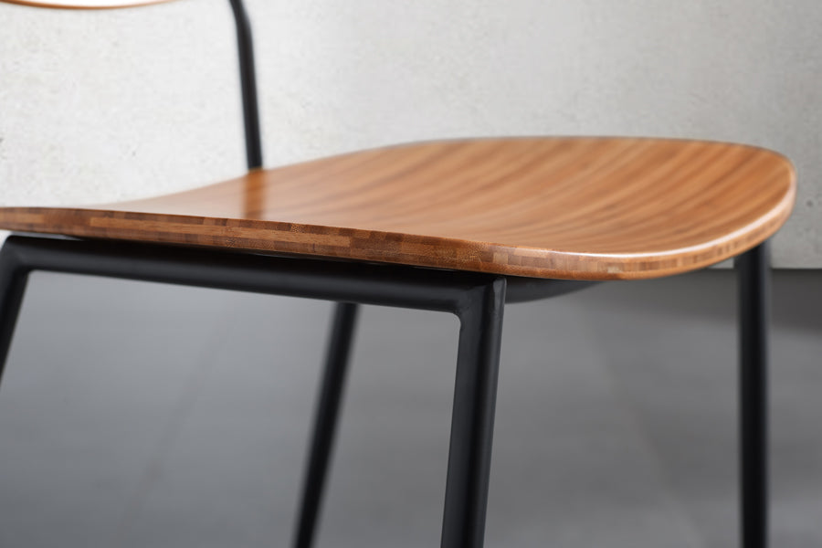 Soho Amber Dining Chair by Greenington, showing closeup view of amber dining chair in live shot.