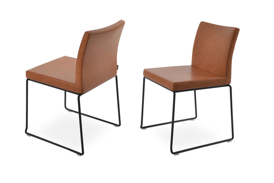 Aria Stackable Dining Chair by sohoConcept, showning two stackable dining chairs in caramel ppm with black finish base.