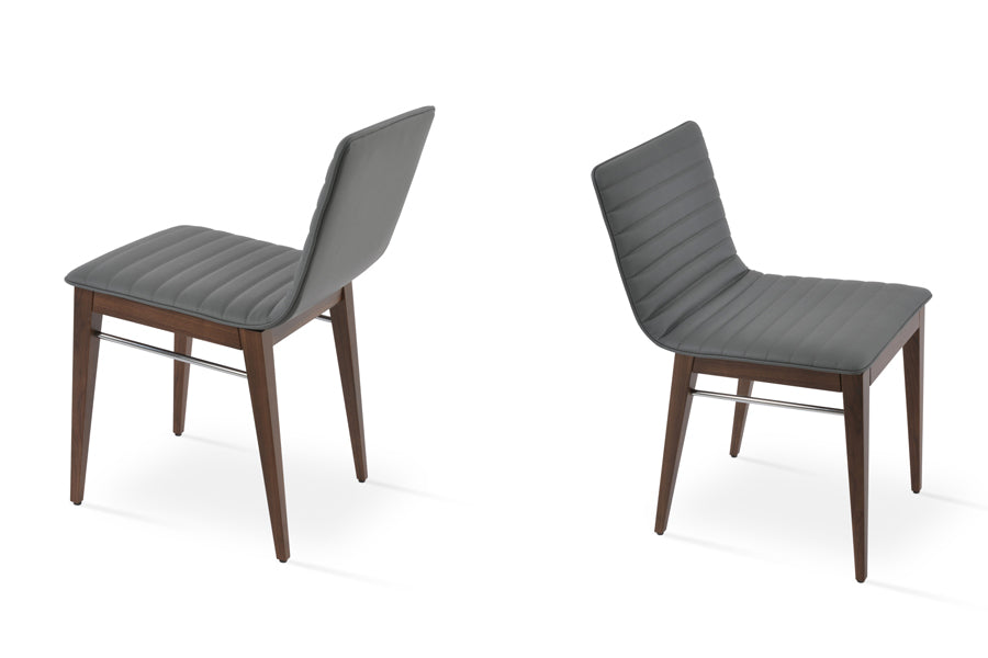 Corona Full Upholstery Wood Dining Chair by SohoConcept, showing angle view of two chairs in grey leatherette with walnut finish.