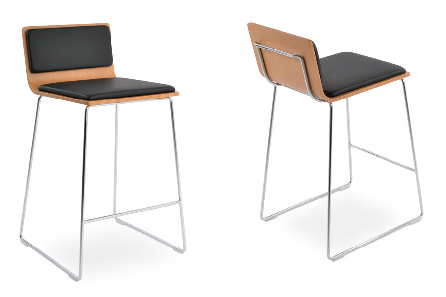 Corona Handle Back Wire Counter Stool by SohoConcept, showing angle view of two stools in black leatherette seat pad, natural plywood seat with chrome wire base.