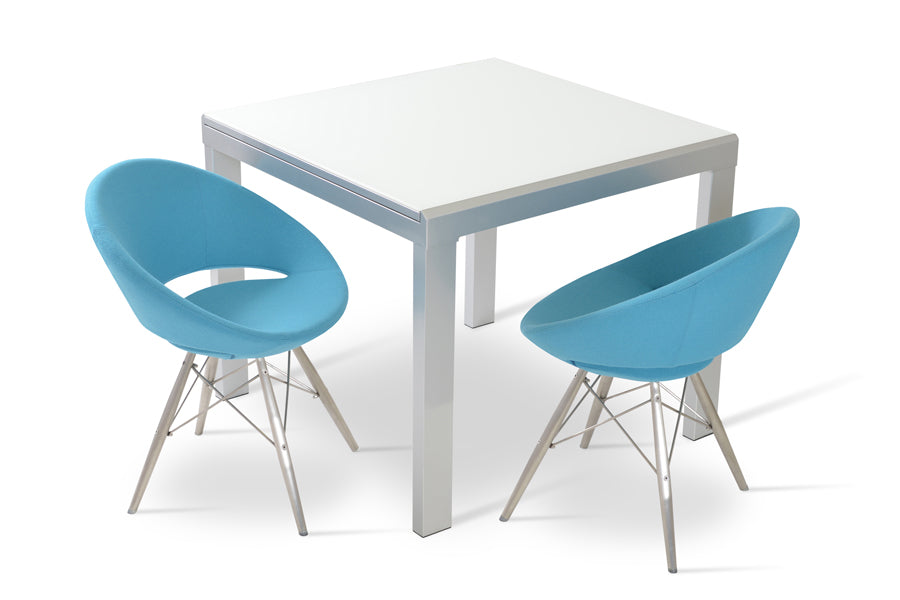 Crescent MW Dining Chair by SohoConcept, showing two chairs in camira blazer turquoise wool with stainless steel base & niagara extendable table.