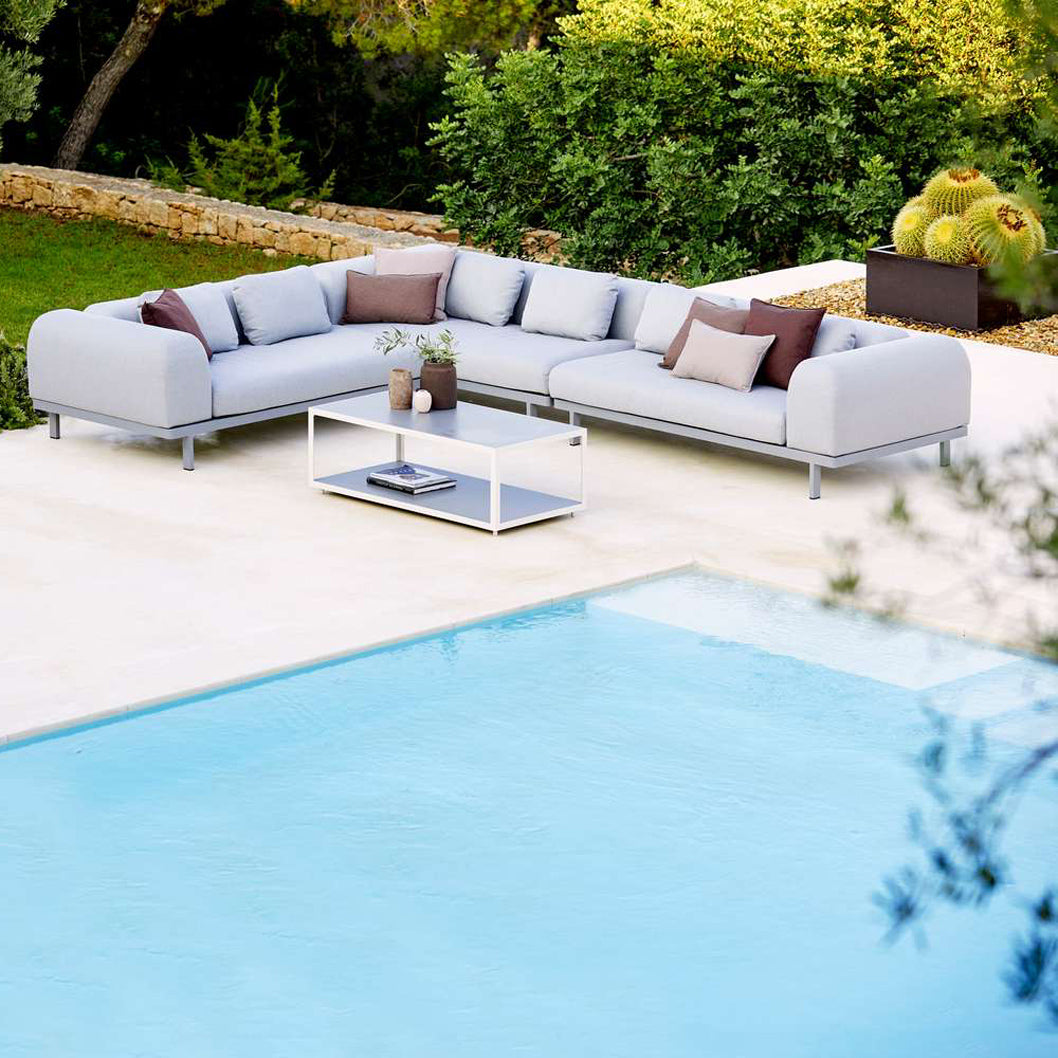 Space 2-Seater Module Sofa by Cane-Line, showing space 2-seater module sofas with table in live shot.