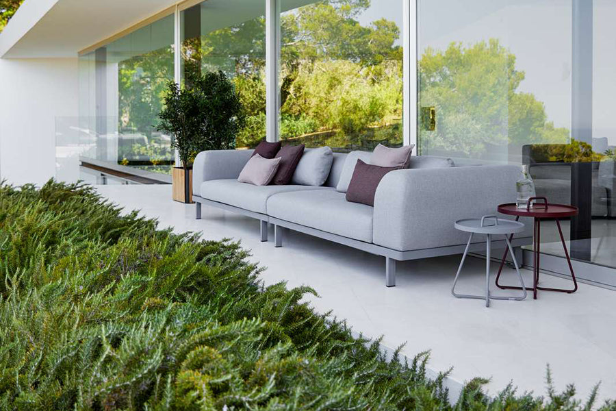 Space 2-Seater Module Sofa by Cane-Line, showing space 2-seater module sofas with table in live shot.