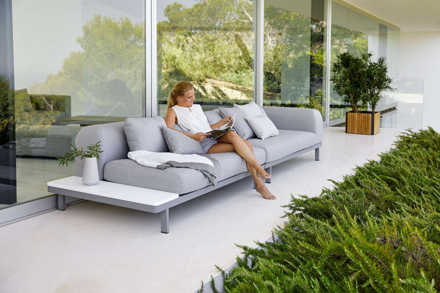 Space 2-Seater Module Sofa by Cane-Line, showing space 2-seater module sofas with table in live shot.