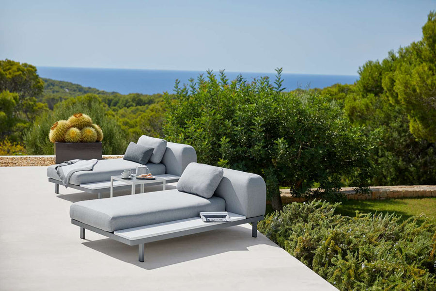 Space 2-Seater Module Sofa by Cane-Line, showing space 2-seater module sofas with table in live shot.