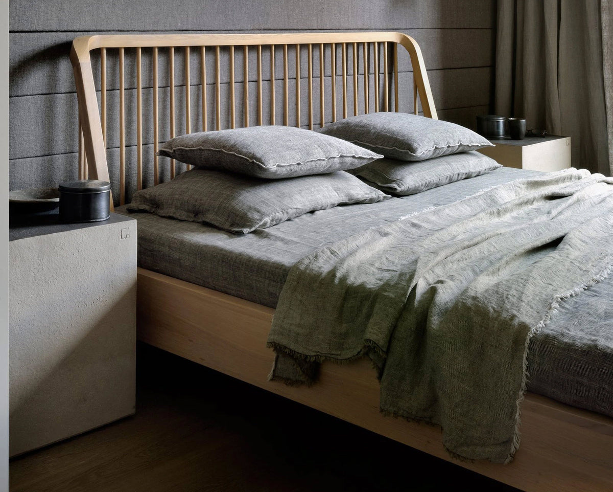 Spindle Bed with Slats by Ethnicraft, showing angle view of bed with slats in live shot.