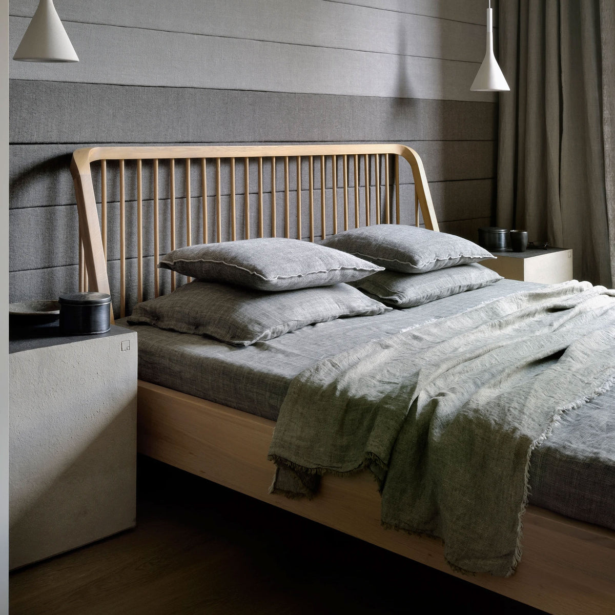 Spindle Bed with Slats by Ethnicraft, showing angle view of bed with slats in live shot.