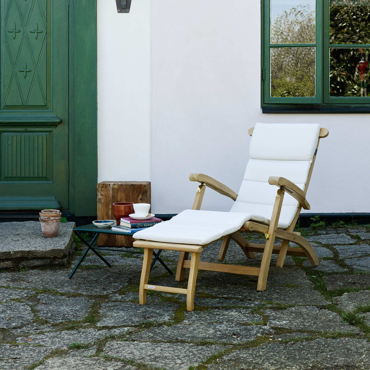 Steamer Deck Chair by Skagerak, showing steamer deck chair with cushion in live shot.