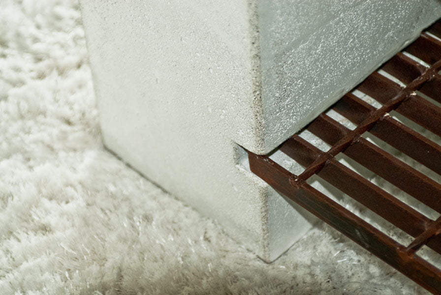 James De Wulf Steel Grating Coffee Table by De Wulf, showing steel grating coffee table with sectional sofa in live shot.