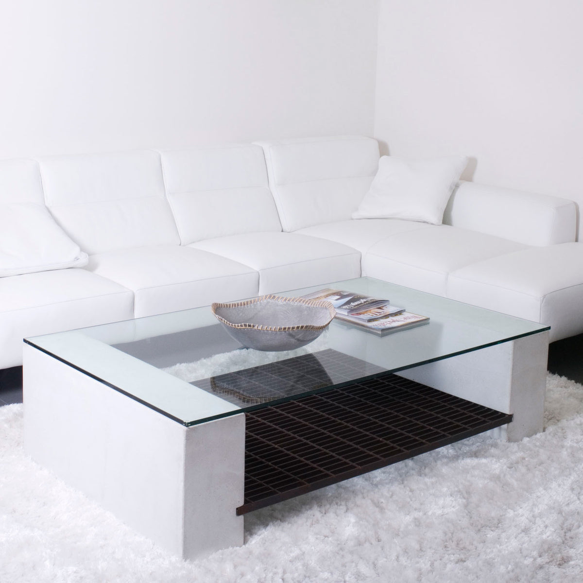 James De Wulf Steel Grating Coffee Table by De Wulf, showing steel grating coffee table with sectional sofa in live shot.