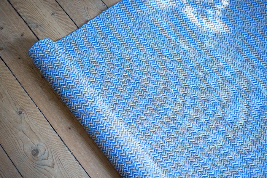 Strand Woven Plastic Rug by Brita, showing closeup view of strand woven plastic rug in live shot.
