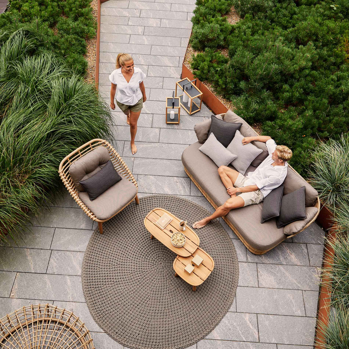 Strington Outdoor Teak Lounge Chair by Cane-Line, showing strington outdoor teak lounge chair with sofa & tables in live shot.
