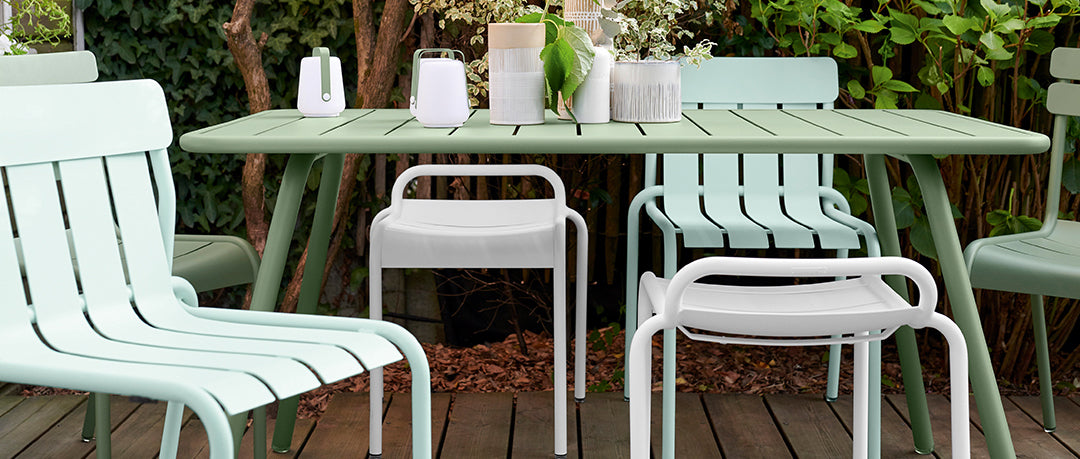 Stripe Side Chair by Fermob, showing of stripe side chair with table & stool in live shot.
