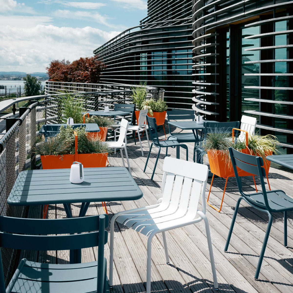 Stripe Side Chair by Fermob, showing of stripe side chair with table in live shot.