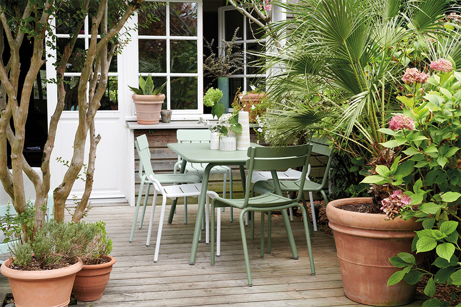 Stripe Side Chair by Fermob, showing of stripe side chair with table in live shot.