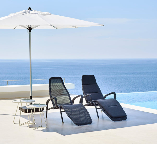 Sunrise Stackable Relaxing Chair by Cane-Line, showing sunrise stackable relaxing chairs in live shot.