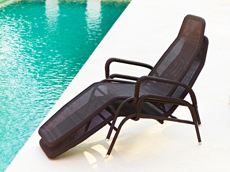 Sunrise Stackable Relaxing Chair by Cane-Line, showing sunrise stackable relaxing chairs in live shot.