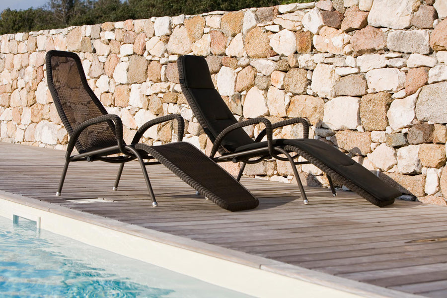 Sunrise Stackable Relaxing Chair by Cane-Line, showing sunrise stackable relaxing chairs in live shot.