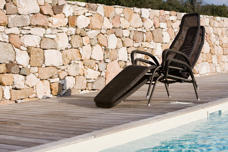 Sunrise Stackable Relaxing Chair by Cane-Line, showing sunrise stackable relaxing chairs in live shot.