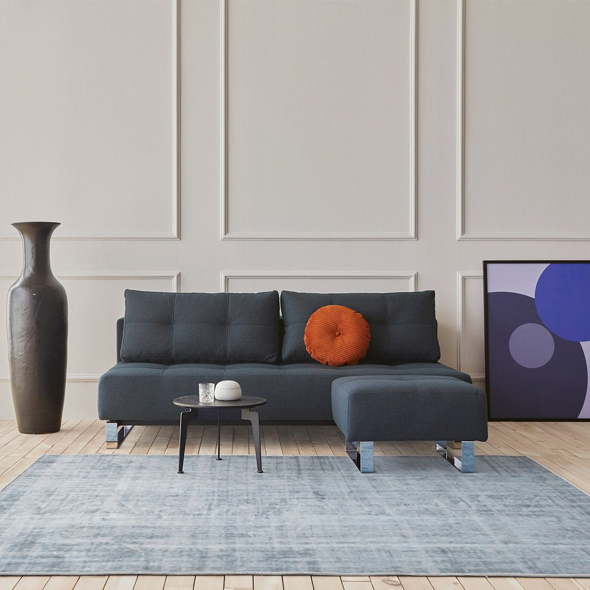 Supremax/Cassius D.E.L. Ottoman by Innovation, showing supremax/cassius d.e.l. ottoman with sofa bed & table in live shot.