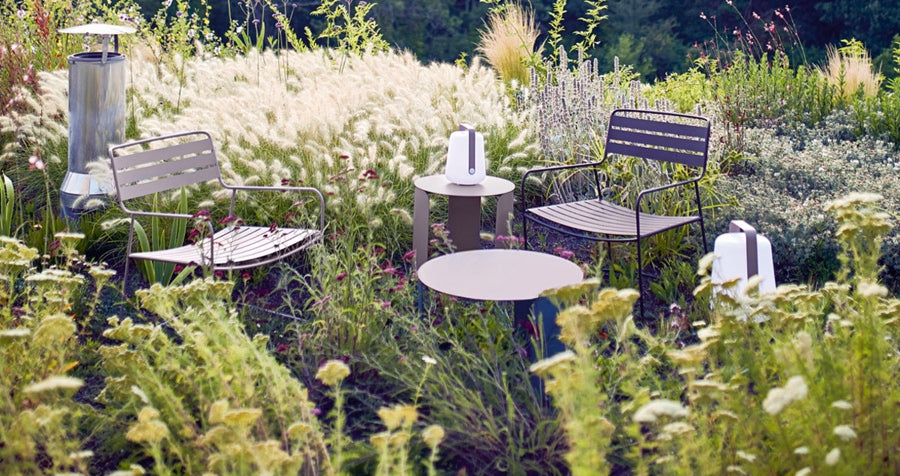 Surprising Low Armchair by Fermob, showing low armchair with table & lamps in live shot.