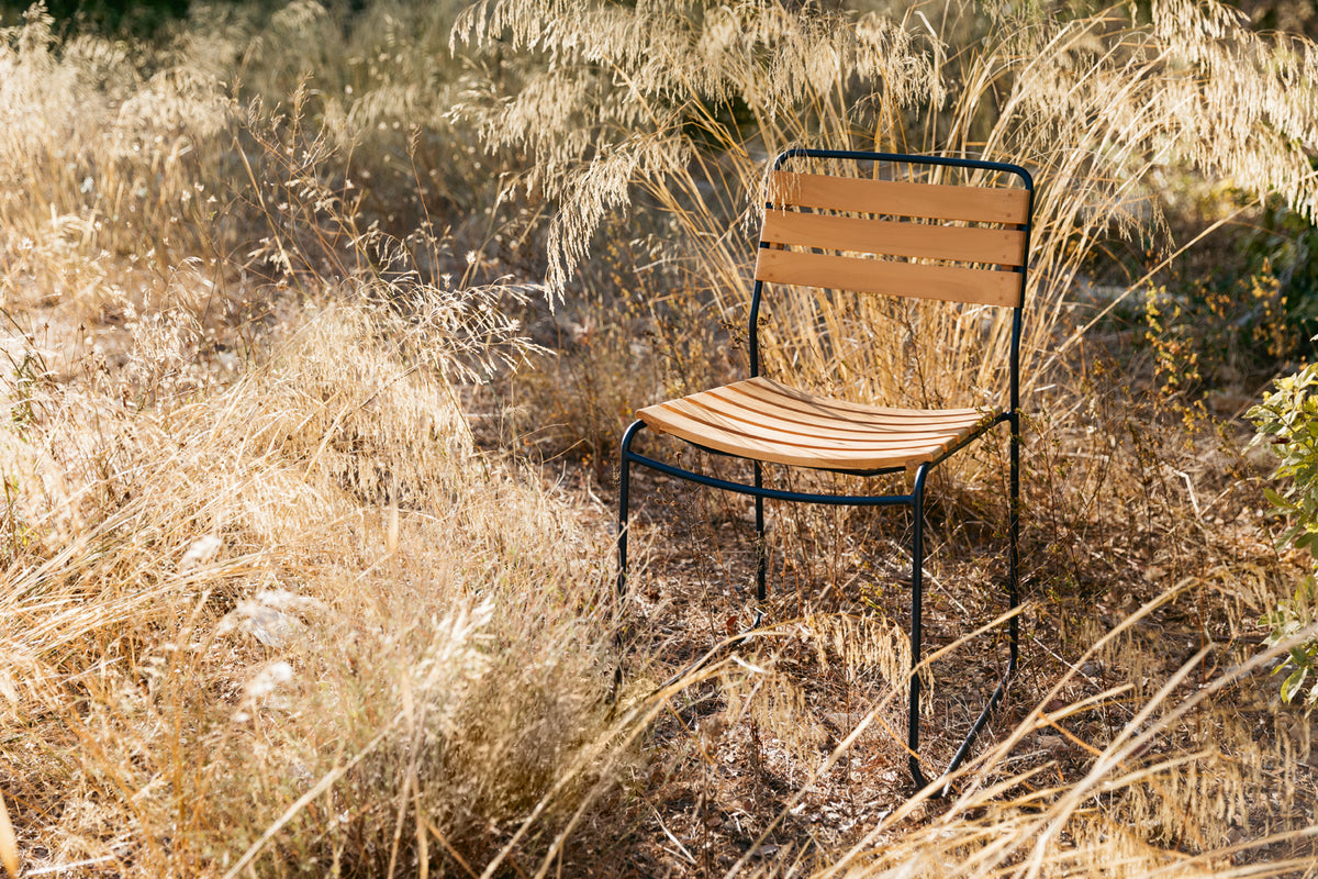 Surprising Teak Chair by Fermob, showing angle view of chair in the live shot.