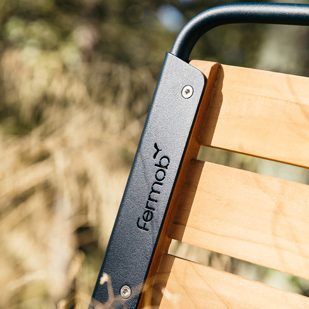 Surprising Teak Chair by Fermob, showing closeup view of chair in the live shot.