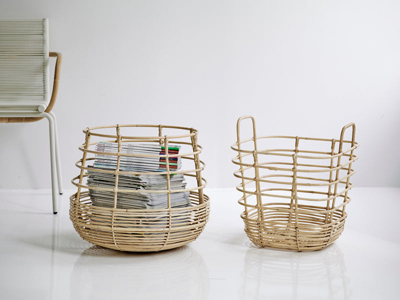 Sweep Rattan Basket by Cane-Line, showing sweep rattan basket with chair in live shot.