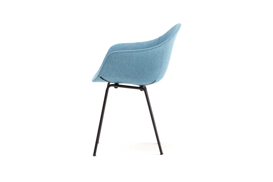 TA Upholstered Armchair by Toou, showing side view of ta upholstered armchair er in black base/ocean blue shell seat.