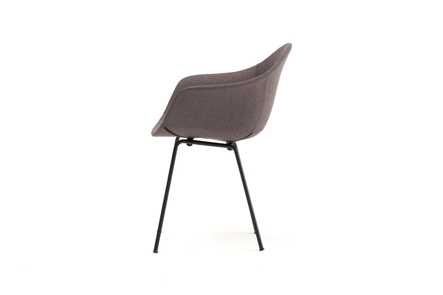TA Upholstered Armchair by Toou, showing side view of ta upholstered armchair er in black base/dark grey shell seat.