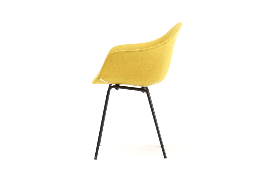 TA Upholstered Armchair by Toou, showing side view of ta upholstered armchair er in black base/mustard shell seat.