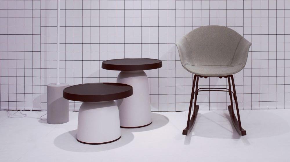 TA Upholstered Rocking Chair by Toou, showing ta upholstered rocking chair with thick top side tables in live shot.