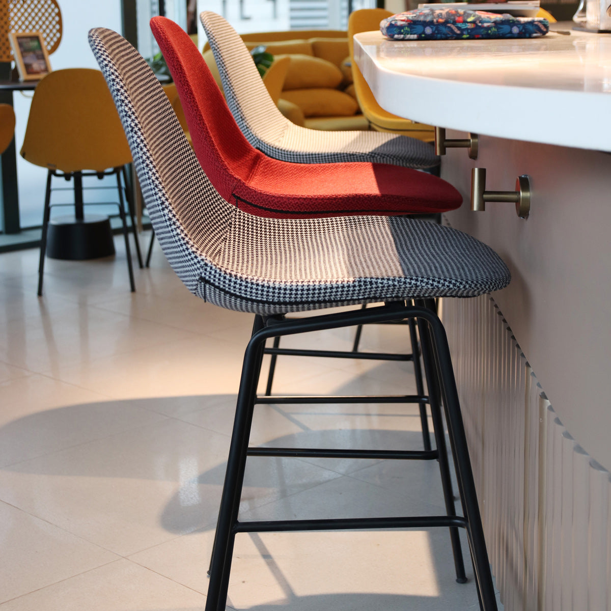 TA XL Upholstered Stool by Toou, showing ta xl upholstered stools in live shot.