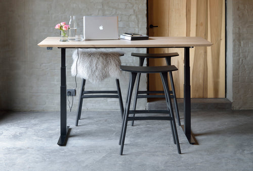 Bok Adjustable Desk by Ethnicraft, showing front view of bok adjustable desk in live shot.