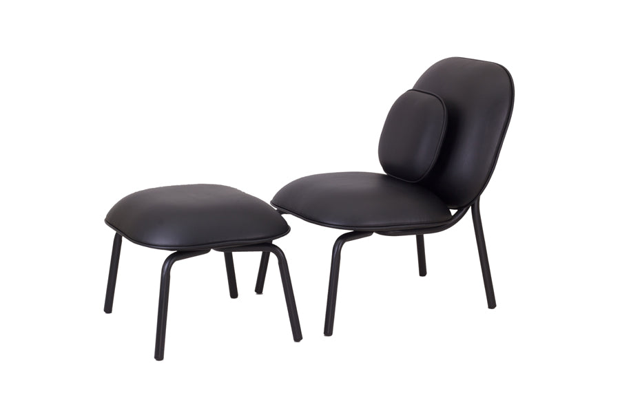 Tasca Ottoman by Toou, showing angle view of tasca ottoman in black eco leather with chair.